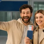 Smiling couple celebrating K-1 fiancé visa approval with U.S. flag in the background