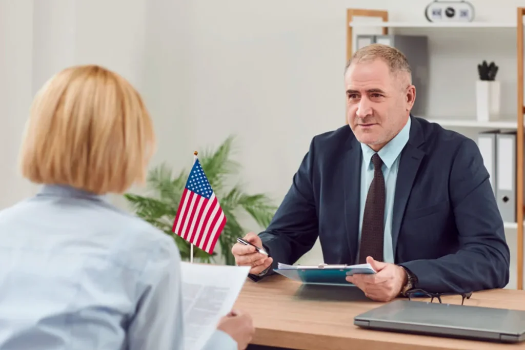 Applicant attending green card interview at a U.S. immigration office with officer present