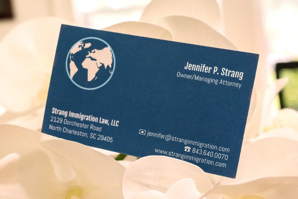 Immigration attorney’s business card displayed in a floral arrangement