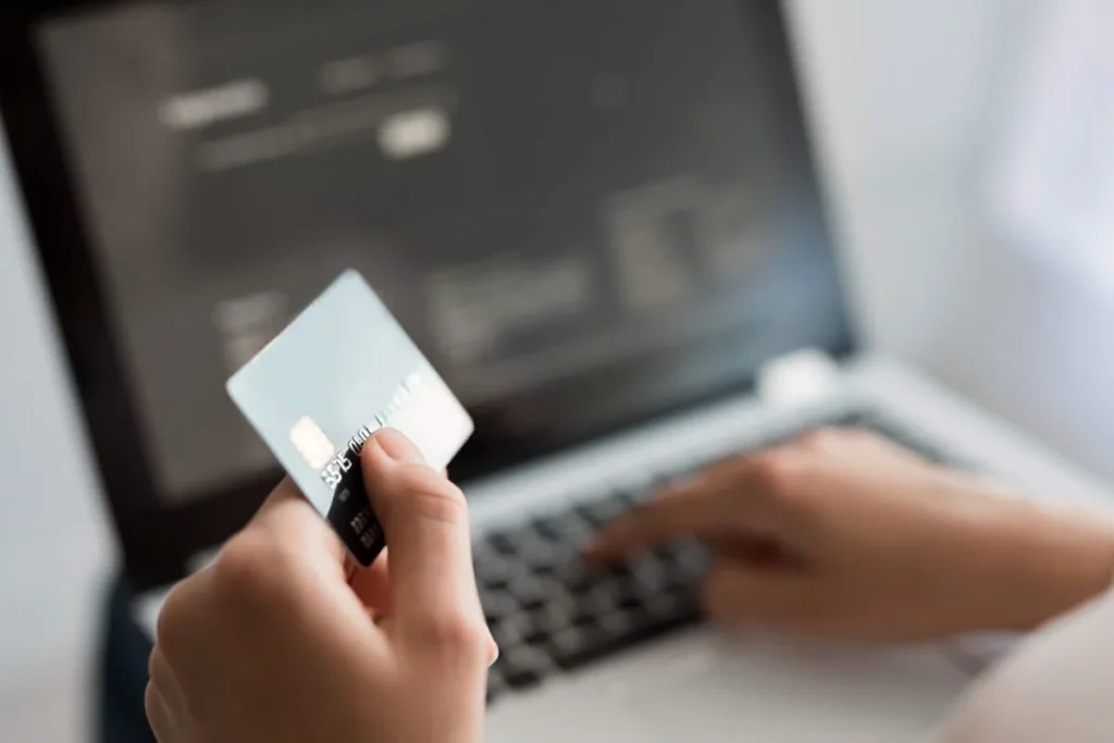 Person making an online payment on a computer for the Affidavit of Support fee.