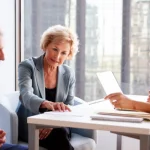 Senior couple reviewing immigration sponsorship requirements with an advisor