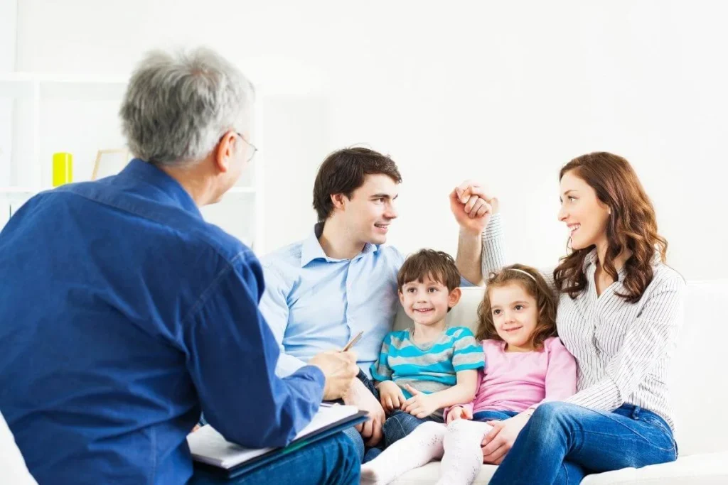 Attorney meets with a couple beside scales of justice and a gavel, illustrating legal guidance related to the American Families United Act.